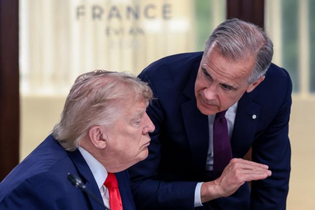 US President Donald Trump (L) speaks with Canada's Prime Minister Mark Carney during a work lunch as part of the G7 summit, in Evian, eastern France, on June 16, 2026. A G7 summit is set to take place June 15 to 17 in the French town of Evian-les-Bains near Switzerland and it will be attended by country leaders as well as the EU's foreign policy chief and ministers from Brazil, Canada, the United Arab Emirates and Turkey. (Photo by Evelyn Hockstein / POOL / AFP)