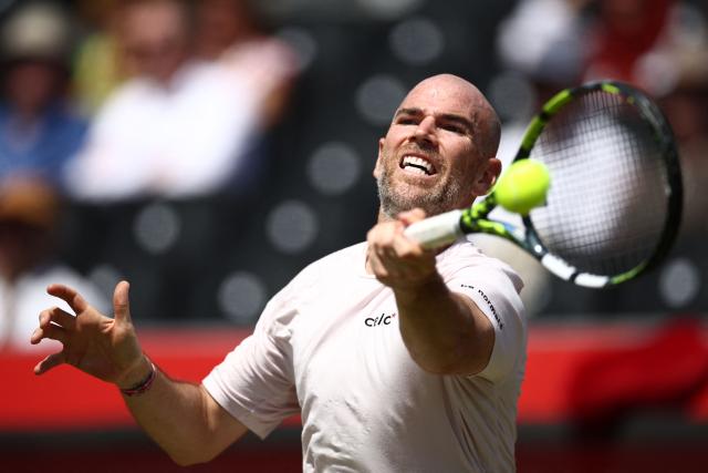 France's Adrian Mannarino returns against Czech Republic's Jakub Mensik during their men's singles round of 32 tennis match on day two of the ATP HSBC Championships at Queen's Club in west London on June 16, 2026. (Photo by Henry Nicholls / AFP)