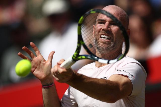 France's Adrian Mannarino returns against Czech Republic's Jakub Mensik during their men's singles round of 32 tennis match on day two of the ATP HSBC Championships at Queen's Club in west London on June 16, 2026. (Photo by Henry Nicholls / AFP)