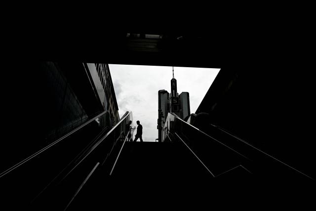 A pedestrian walks past the Commerzbank building in the banking district in Frankfurt am Main, western Germany, on June 16, 2026. Tuesday, June 16, marks the final day for UniCredit's hostile and highly political takeover offer for Commerzbank, as Italy's second-largest bank has its sights on an ambitious pan-European banking merger. (Photo by Kirill KUDRYAVTSEV / AFP)