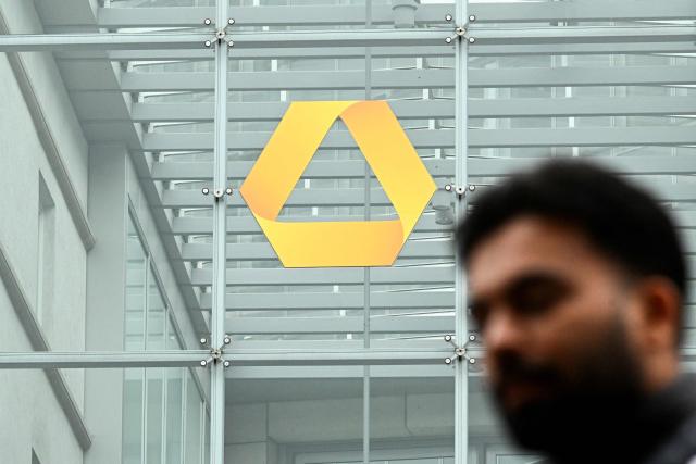 A pedestrian walks past the Commerzbank building in the banking district in Frankfurt am Main, western Germany, on June 16, 2026. Tuesday, June 16, marks the final day for UniCredit's hostile and highly political takeover offer for Commerzbank, as Italy's second-largest bank has its sights on an ambitious pan-European banking merger. (Photo by Kirill KUDRYAVTSEV / AFP)