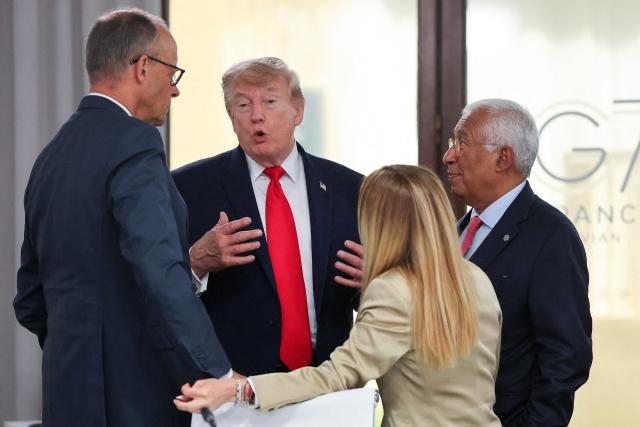 US President Donald Trump (C) speaks with Germany's Chancellor Friedrich Merz, European Council President Antonio Costa and Italy's Prime Minister Giorgia Melonia during a work lunch as part of the G7 summit, in Evian, eastern France, on June 16, 2026. A G7 summit is set to take place June 15 to 17 in the French town of Evian-les-Bains near Switzerland and it will be attended by country leaders as well as the EU's foreign policy chief and ministers from Brazil, Canada, the United Arab Emirates and Turkey. (Photo by Christian Hartmann / POOL / AFP)