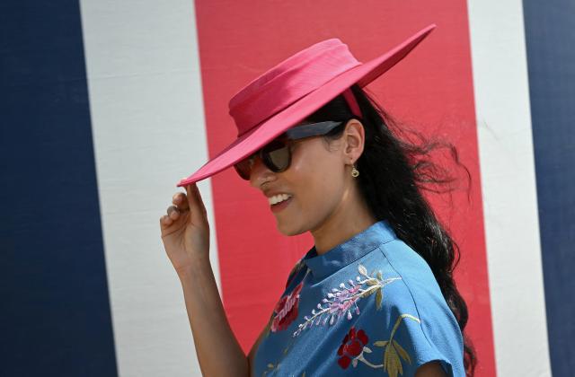 A racegoer poses for a photograph as they arrive on the first day of the Royal Ascot horse racing meeting in Ascot, west of London, on June 16, 2026. (Photo by JUSTIN TALLIS / AFP)