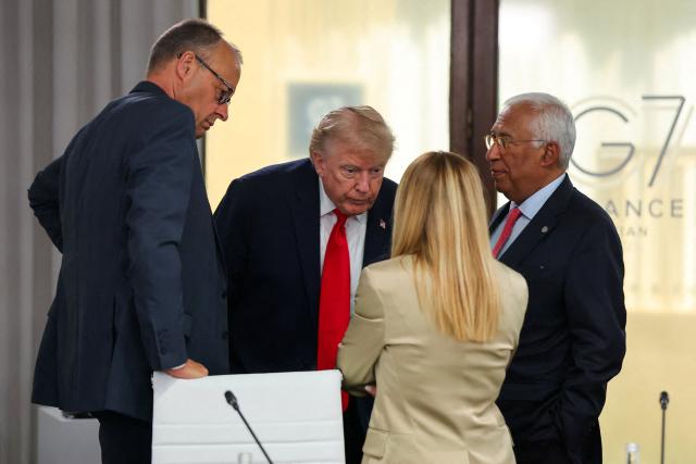 (From L) Germanys Chancellor Friedrich Merz, US President Donald Trump, Italy's Prime Minister Giorgia Meloni and European Council President Antonio Costa attend a work lunch as part of the G7 summit, in Evian, eastern France, on June 16, 2026. A G7 summit is set to take place June 15 to 17 in the French town of Evian-les-Bains near Switzerland and it will be attended by country leaders as well as the EU's foreign policy chief and ministers from Brazil, Canada, the United Arab Emirates and Turkey. (Photo by Christian Hartmann / POOL / AFP)