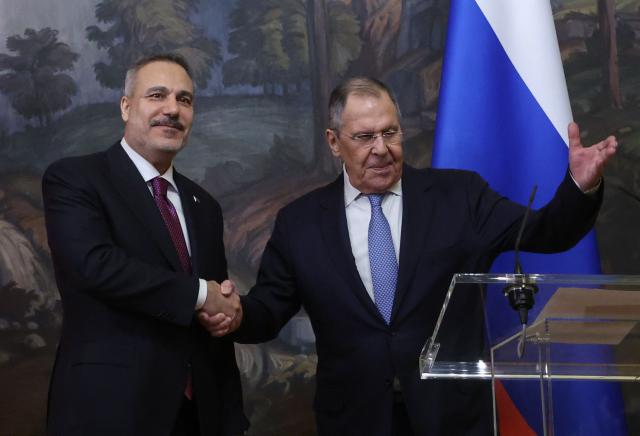 Russian Foreign Minister Sergei Lavrov and his Turkish counterpart Hakan Fidan shake hands during a joint press conference following their meeting in Moscow on June 16, 2026. (Photo by SERGEI ILNITSKY / POOL / AFP)