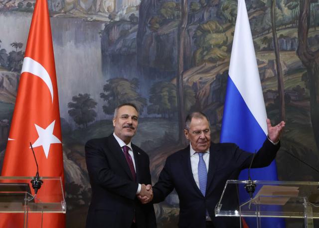 Russian Foreign Minister Sergei Lavrov and his Turkish counterpart Hakan Fidan shake hands during a joint press conference following their meeting in Moscow on June 16, 2026. (Photo by SERGEI ILNITSKY / POOL / AFP)