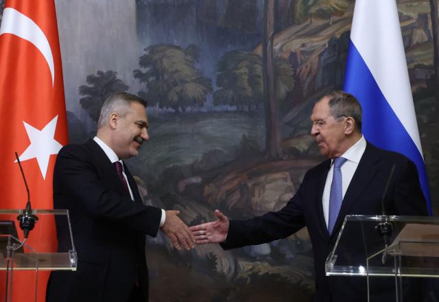 Russian Foreign Minister Sergei Lavrov and his Turkish counterpart Hakan Fidan shake hands during a joint press conference following their meeting in Moscow on June 16, 2026. (Photo by SERGEI ILNITSKY / POOL / AFP)