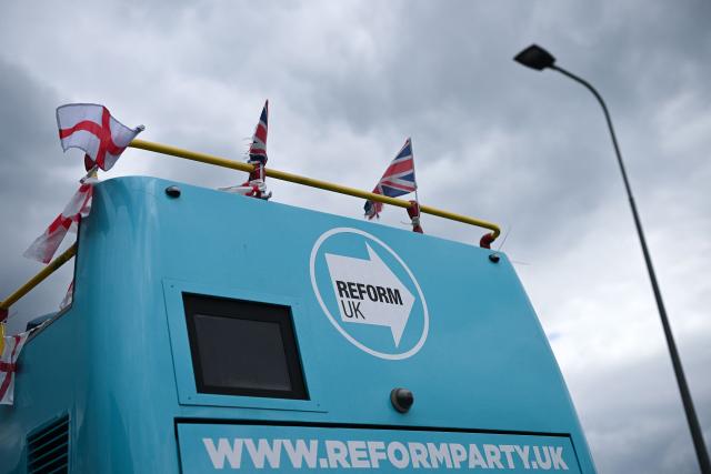 A poster for the Reform UK party, is pictured in the political party's campaign bus, in Makerfield, north-west England on June 16, 2026, ahead of the forthcoming by-election on June 18. Britain holds a special vote on June 18 that is expected to set in motion an attempt to oust Labour leader Keir Starmer as prime minister. (Photo by Oli SCARFF / AFP)