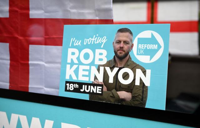 A poster for Reform UK's candidate, Rob Kenyon, is pictured in the political party's campaign bus, in Makerfield, north-west England on June 16, 2026, ahead of the forthcoming by-election on June 18. Britain holds a special vote on June 18 that is expected to set in motion an attempt to oust Labour leader Keir Starmer as prime minister. (Photo by Oli SCARFF / AFP)