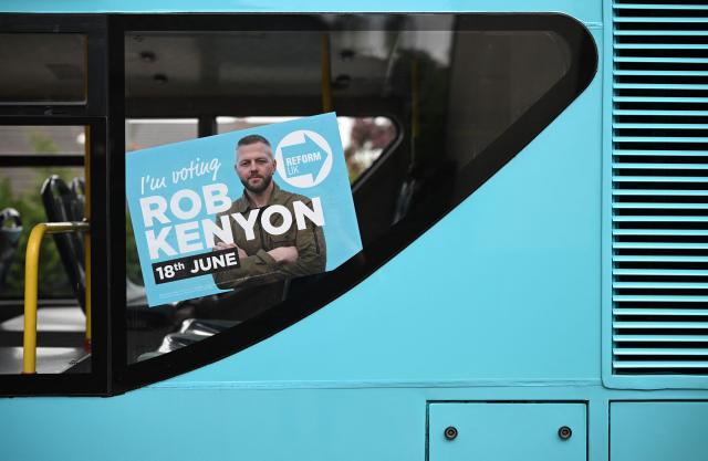 A poster for the Reform UK party, is pictured in the political party's campaign bus, in Makerfield, north-west England on June 16, 2026, ahead of the forthcoming by-election on June 18. Britain holds a special vote on June 18 that is expected to set in motion an attempt to oust Labour leader Keir Starmer as prime minister. (Photo by Oli SCARFF / AFP)