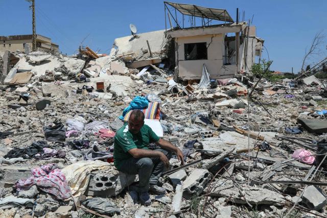 A man sits on the rubble of his home as residents return to the southern village of Srifa on June 16, 2026. Lebanon's president and prime minister on June 16 discussed preparations for a new round of talks with Israel next week, after the US and Iran announced a peace deal that includes Lebanon. Lebanon and Israel have been holding direct talks in Washington since April, seeking to end hostilities and separate the Israel-Hezbollah conflict from the wider regional war. (Photo by Kawnat HAJU / AFP) / 