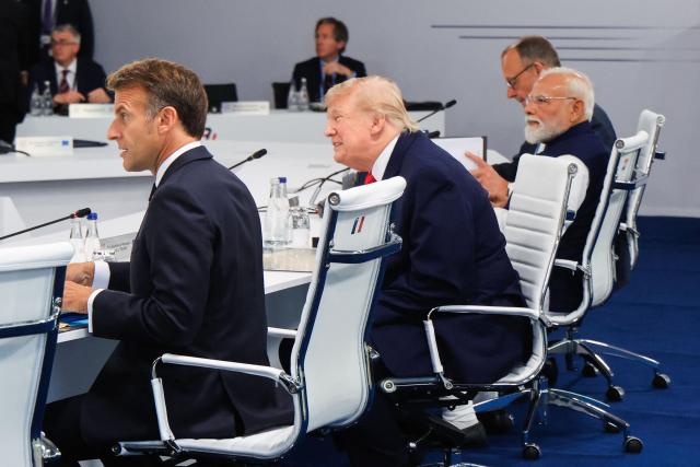 (From L) France's President Emmanuel Macron, US President Donald Trump and India's Prime Minister Narendra Modi attend a work meeting as part of the G7 summit, in Evian, eastern France, on June 16, 2026. A G7 summit is set to take place June 15 to 17 in the French town of Evian-les-Bains near Switzerland and it will be attended by country leaders as well as the EU's foreign policy chief and ministers from Brazil, Canada, the United Arab Emirates and Turkey. (Photo by Ludovic MARIN / AFP)