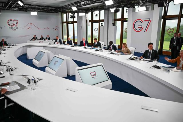 (From L) Germanys Chancellor Friedrich Merz, India's Prime Minister Narendra Modi, US President Donald Trump, France's President Emmanuel Macron, Kenya's President William Ruto, Italy's Prime Minister Giorgia Meloni, South Korea's President Lee Jae-myung and European Commission President Ursula von der Leyen attend a work meeting as part of the G7 summit, in Evian, eastern France, on June 16, 2026. A G7 summit is set to take place June 15 to 17 in the French town of Evian-les-Bains near Switzerland and it will be attended by country leaders as well as the EU's foreign policy chief and ministers from Brazil, Canada, the United Arab Emirates and Turkey. (Photo by Mandel NGAN / AFP)