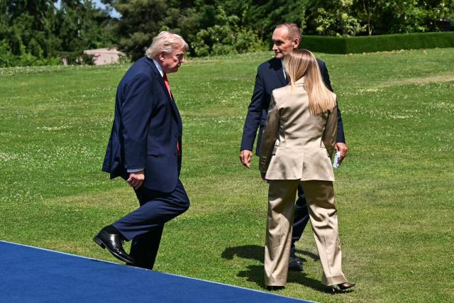 US President Donald Trump (L) and Italy's Prime Minister Giorgia Meloni (R) leave with Director of State Protocol and Diplomatic Events Frederic Billet after a family photograph during the G7 summit, in Evian, eastern France, on June 16, 2026. A G7 summit is set to take place June 15 to 17 in the French town of Evian-les-Bains near Switzerland and it will be attended by country leaders as well as the EU's foreign policy chief and ministers from Brazil, Canada, the United Arab Emirates and Turkey. (Photo by Mandel NGAN / AFP)