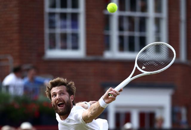 France's Corentin Moutet attempts to return against France's Giovanni Mpetshi Perricard during their men's singles round of 32 tennis match on day two of the ATP HSBC Championships at Queen's Club in west London on June 16, 2026. (Photo by Henry NICHOLLS / AFP)