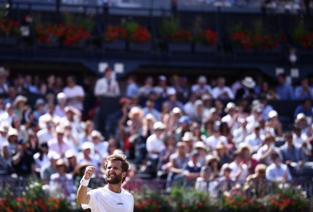 France's Corentin Moutet reacts whilst playing against France's Giovanni Mpetshi Perricard during their men's singles round of 32 tennis match on day two of the ATP HSBC Championships at Queen's Club in west London on June 16, 2026. (Photo by Henry NICHOLLS / AFP)