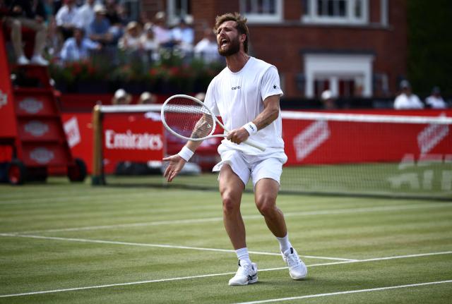 France's Corentin Moutet reacts whilst playing against France's Giovanni Mpetshi Perricard during their men's singles round of 32 tennis match on day two of the ATP HSBC Championships at Queen's Club in west London on June 16, 2026. (Photo by Henry NICHOLLS / AFP)