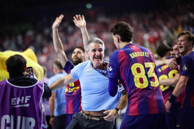 FC Barcelona's Spanish headcoach Antonio Carlos Ortega Perez (C) and his players celebrate after the EHF Men's Handball Champions League Final 4 final between Barca and Fuechse Berlin in Cologne, western Germany on June 14, 2026. Barca won the match 37:34. (Photo by Ronny HARTMANN / AFP)