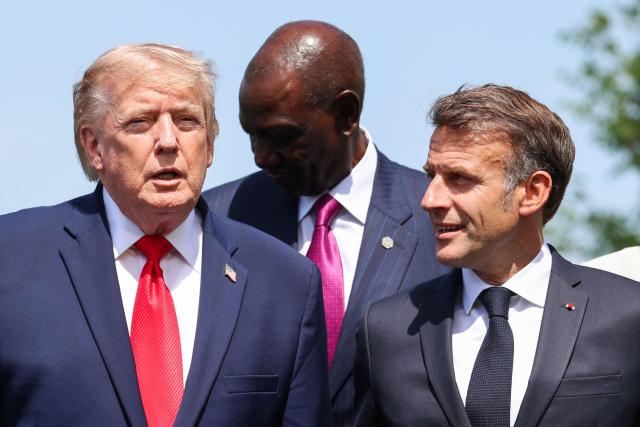 US President Donald Trump and France's President Emmanuel Macron pose during a family photograph as part of the G7 summit, in Evian, eastern France, on June 16, 2026. A G7 summit is set to take place June 15 to 17 in the French town of Evian-les-Bains near Switzerland and it will be attended by country leaders as well as the EU's foreign policy chief and ministers from Brazil, Canada, the United Arab Emirates and Turkey. (Photo by Ludovic MARIN / POOL / AFP)