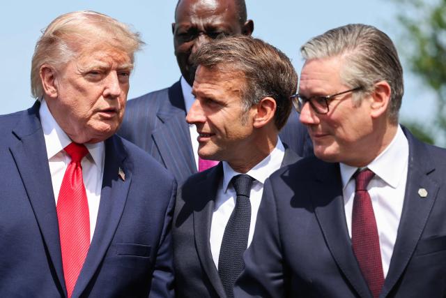 US President Donald Trump speaks with France's President Emmanuel Macron next to Britain's Prime Minister Keir Starmer during a family photograph as part of the G7 summit, in Evian, eastern France, on June 16, 2026. A G7 summit is set to take place June 15 to 17 in the French town of Evian-les-Bains near Switzerland and it will be attended by country leaders as well as the EU's foreign policy chief and ministers from Brazil, Canada, the United Arab Emirates and Turkey. (Photo by Ludovic MARIN / POOL / AFP)