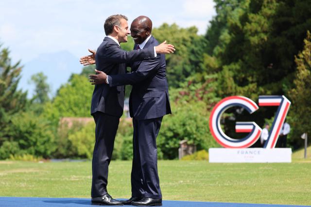 France's President Emmanuel Macron welcomes Kenya's President William Ruto (R) for the official greeting ahead of a work lunch as part of the G7 summit, in Evian, eastern France, on June 16, 2026. A G7 summit is set to take place June 15 to 17 in the French town of Evian-les-Bains near Switzerland and it will be attended by country leaders as well as the EU's foreign policy chief and ministers from Brazil, Canada, the United Arab Emirates and Turkey. (Photo by Ludovic MARIN / AFP)