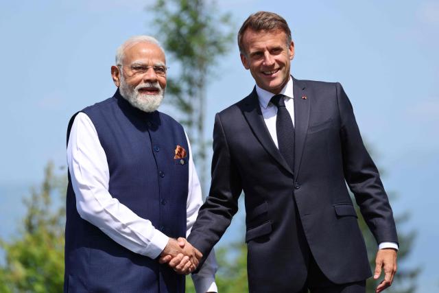 France's President Emmanuel Macron (R) welcomes India's Prime Minister Narendra Modi for the official greeting ahead of a work lunch as part of the G7 summit, in Evian, eastern France, on June 16, 2026. A G7 summit is set to take place June 15 to 17 in the French town of Evian-les-Bains near Switzerland and it will be attended by country leaders as well as the EU's foreign policy chief and ministers from Brazil, Canada, the United Arab Emirates and Turkey. (Photo by Ludovic MARIN / AFP)
