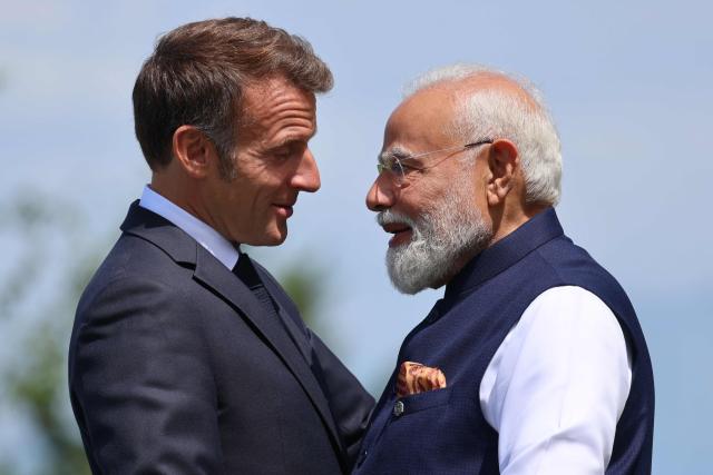 France's President Emmanuel Macron (L) welcomes India's Prime Minister Narendra Modi for the official greeting ahead of a work lunch as part of the G7 summit, in Evian, eastern France, on June 16, 2026. A G7 summit is set to take place June 15 to 17 in the French town of Evian-les-Bains near Switzerland and it will be attended by country leaders as well as the EU's foreign policy chief and ministers from Brazil, Canada, the United Arab Emirates and Turkey. (Photo by Ludovic MARIN / AFP)