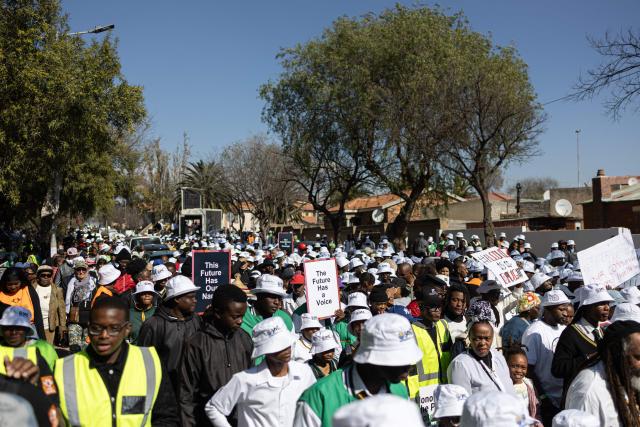 Attendees march and hold placards during a march marking the 50th anniversary of the June 16, 1976 Soweto Uprising, organised by 1976 @ Fifty, in Soweto near Johannesburg, on June 16, 2026. June 16 is commemorated as Youth Day in South Africa, honouring the thousands of Black school students who took to the streets in 1976 to protest against the apartheid government’s imposition of Afrikaans as a language of instruction, and the students who were killed and injured when police opened fire on the demonstration. (Photo by EMMANUEL CROSET / AFP)