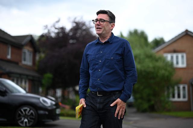 Andy Burnham, Labour's candidate in the forthcoming Makerfield by-election on June 18, canvasses voters in Hindley, north-west England on June 16, 2026. (Photo by Oli SCARFF / AFP)