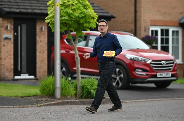 Andy Burnham, Labour's candidate in the forthcoming Makerfield by-election on June 18, canvasses voters in Hindley, north-west England on June 16, 2026. (Photo by Oli SCARFF / AFP)