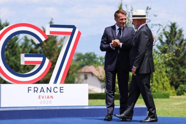 France's President Emmanuel Macron (L) welcomes and shakes hands with Brazilian politician Luiz Inacio Lula Da Silva for the official greeting ahead of a work lunch as part of the G7 summit, in Evian, eastern France, on June 16, 2026. A G7 summit is set to take place June 15 to 17 in the French town of Evian-les-Bains near Switzerland and it will be attended by country leaders as well as the EU's foreign policy chief and ministers from Brazil, Canada, the United Arab Emirates and Turkey. (Photo by Ludovic MARIN / AFP)