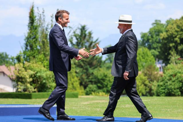 France's President Emmanuel Macron (L) welcomes and shakes hands with Brazilian politician Luiz Inacio Lula Da Silva for the official greeting ahead of a work lunch as part of the G7 summit, in Evian, eastern France, on June 16, 2026. A G7 summit is set to take place June 15 to 17 in the French town of Evian-les-Bains near Switzerland and it will be attended by country leaders as well as the EU's foreign policy chief and ministers from Brazil, Canada, the United Arab Emirates and Turkey. (Photo by Ludovic MARIN / AFP)