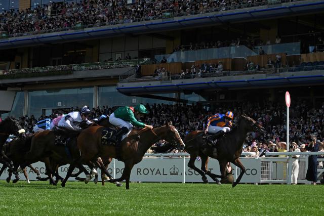 Jockey Ryan Moore rides Mission Central (R) to win, ahead of second-placed jockey Mickael Barzalona on Rayevka (2L) and third-placed jockey Joshua Parr on Overpass in the King Charles III Stakes horse race on the first day of the Royal Ascot horse racing meeting in Ascot, west of London, on June 16, 2026. (Photo by JUSTIN TALLIS / AFP)