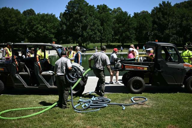 Members of the National Park Service work near the Lincoln Memorial Reflecting Pool following the completion of recent renovations in Washington, DC, on June 16, 2026. The reflecting pool project, undertaken as part of President Donald Trump’s preparations for the nation’s 250th anniversary, began in April and was completed last week. (Photo by Brendan SMIALOWSKI / AFP)