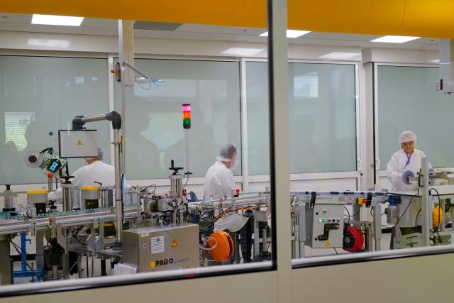 Employees work on a production line for clinical trials on a global scale during a press visit to the industrial site of the French pharmaceutical group Sanofi in Montpellier, southern France, on June 16, 2026. (Photo by Sylvain THOMAS / AFP)