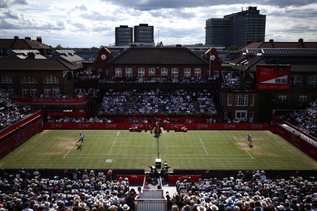Canada's Gabriel Diallo returns to Australia's Alex de Minaur during their men's singles round of 32 tennis match on day two of the ATP HSBC Championships at Queen's Club in west London on June 16, 2026. (Photo by Henry NICHOLLS / AFP)
