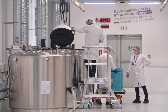 Employees work on a CryoPark production line during a press visit at the industrial site of the French pharmaceutical group Sanofi in Montpellier, in the south of France, on June 16, 2026. The CryoPark is a facility dedicated to the storage and global distribution of biological products and samples at very low temperatures, particularly for messenger RNA vaccines, gene therapies, and other biopharmaceutical innovations. (Photo by Sylvain THOMAS / AFP)