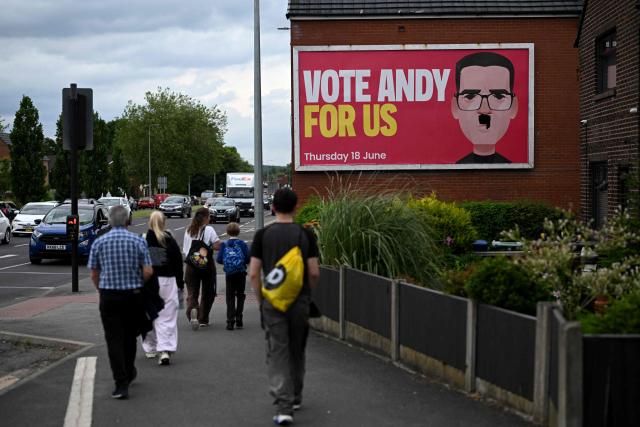 A defaced poster for the Labour party candidate, Greater Manchester Mayor Andy Burnham, is pictured on the side of residential property ahead of the Makerfield by-election on June 18, in west of Manchester, north-west England on June 16, 2026. Britain holds a special vote on June 18 that is expected to set in motion an attempt to oust Labour leader Keir Starmer as prime minister. (Photo by Oli SCARFF / AFP)