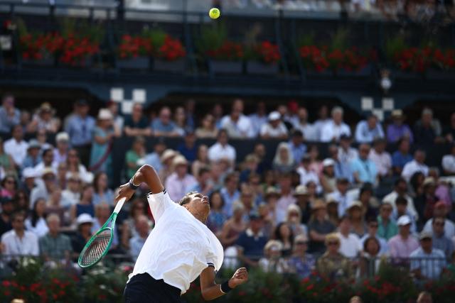 Canada's Gabriel Diallo serves against Australia's Alex de Minaur during their men's singles round of 32 tennis match on day two of the ATP HSBC Championships at Queen's Club in west London on June 16, 2026. (Photo by Henry NICHOLLS / AFP)