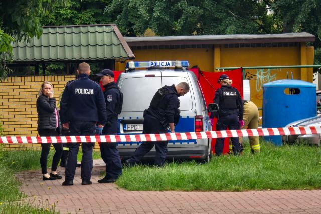 TOPSHOT - Police work at a crime scene covered with a tent (back R) in Biala Podlaska, eastern Poland  on June 16, 2026, where Russian artist Semyon Skrepetsky, known for his satirising Russian President Putin has been shot dead. "An investigation is being conducted... into the murder of a 44-year-old citizen of the Russian Federation... known in the media as Semyon Skrepetsky," a spokesman for the prosecutor's office in Lublin, Marcin Kozak, told journalists. Two Belarusian nationals have been arrested in connection with the killing, he added. They were detained in the vicinity of the Belarusian consulate in Biala Podlaska in eastern Poland, where the killing took place. (Photo by Piotr PYRKOSZ / Slowo Podlasia / AFP)