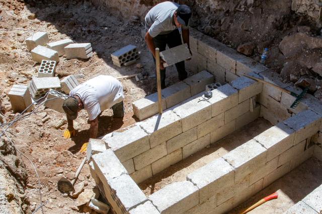 Workers dig and prepare foundations of new graves at the village of Deir Qanoun al-Nahr in southern Lebanon on June 16, 2026. Lebanese state media said that Israeli strikes killed at least four people in the Nabatieh area of the country's south on June 16, despite an announcement that a US-Iran deal included the Israel-Hezbollah war. While violence has declined in Lebanon since the agreement between the US and Iran was announced, Israeli strikes on the south have now killed at least five people since June 15. (Photo by MAHMOUD ZAYYAT / AFP) / 