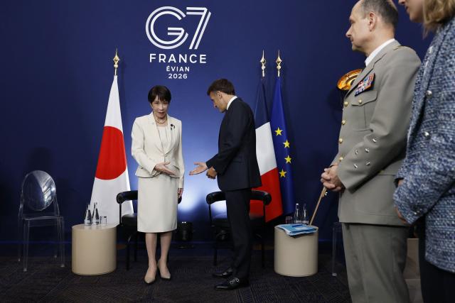 France's President Emmanuel Macron (2nd L) and Japan's Prime Minister Sanae Takaichi (L) attend a bilateral meeting on the sideline of the G7 summit, in Evian, eastern France, on June 16, 2026. A G7 summit is set to take place June 15 to 17 in the French town of Evian-les-Bains near Switzerland and it will be attended by country leaders as well as the EU's foreign policy chief and ministers from Brazil, Canada, the United Arab Emirates and Turkey. (Photo by Yoan VALAT / POOL / AFP)