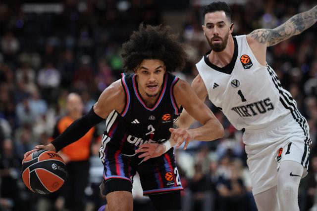 (FILES) Paris Basketball's French-Algerian guard #02 Nadir Hifi (L) fights for the ball during the Euroleague basketball match between Paris Basketball and Virtus Bologna at the Adidas Arena, in Paris, on October 9, 2025. For once, and unlike in recent seasons, the lead roles in the french championship final are being played by Frenchmen: Nadir Hifi has been promoted to starting point guard for Paris Basketball, while Elie Okobo and Matthew Strazel have taken on greater responsibilities at Monaco in the absence of Mike James. The three French internationals will face each other again on June 17, 2026, at the Arena Porte de la Chapelle, for the second game of the final showdown of a season with a distinctly blue-white-red flavour, since only one foreign player made it into the starting five of the regular season. (Photo by Anne-Christine POUJOULAT / AFP)