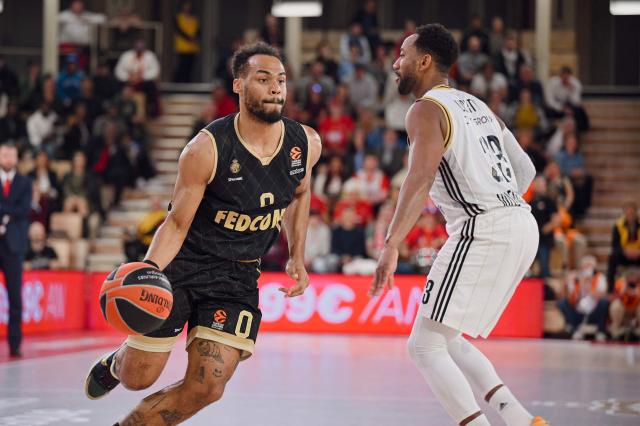 (FILES) Monaco's French guard #0 Elie Okobo bounces the ball during the Euroleague Basketball match between AS Monaco and ASVEL Lyon-Villeurbanne at the Gaston-Medecin arena in Monaco on November 21, 2024. For once, and unlike in recent seasons, the lead roles in the french championship final are being played by Frenchmen: Nadir Hifi has been promoted to starting point guard for Paris Basketball, while Elie Okobo and Matthew Strazel have taken on greater responsibilities at Monaco in the absence of Mike James. The three French internationals will face each other again on June 17, 2026, at the Arena Porte de la Chapelle, for the second game of the final showdown of a season with a distinctly blue-white-red flavour, since only one foreign player made it into the starting five of the regular season. (Photo by Frederic DIDES / AFP)