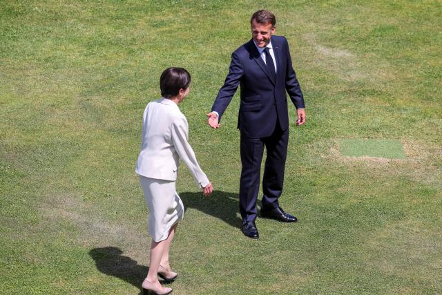 Japan's Prime Minister Sanae Takaichi (L) and France's President Emmanuel Macron walk together after posing for a family photograph during the G7 summit, in Evian, eastern France, on June 16, 2026. A G7 summit is set to take place June 15 to 17 in the French town of Evian-les-Bains near Switzerland and it will be attended by country leaders as well as the EU's foreign policy chief and ministers from Brazil, Canada, the United Arab Emirates and Turkey. (Photo by Dominique JACOVIDES / POOL / AFP)