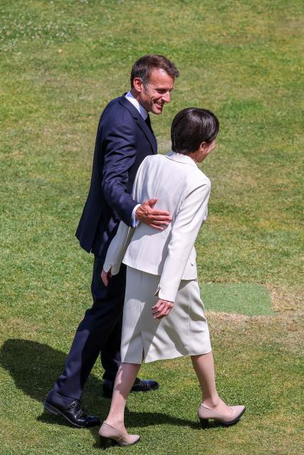 Japan's Prime Minister Sanae Takaichi (R) and France's President Emmanuel Macron walk together after posing for a family photograph during the G7 summit, in Evian, eastern France, on June 16, 2026. A G7 summit is set to take place June 15 to 17 in the French town of Evian-les-Bains near Switzerland and it will be attended by country leaders as well as the EU's foreign policy chief and ministers from Brazil, Canada, the United Arab Emirates and Turkey. (Photo by Dominique JACOVIDES / POOL / AFP)