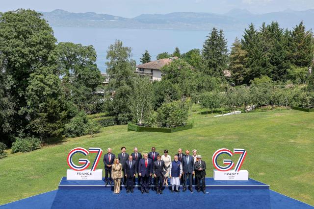 (From L) European Council President Antonio Costa, Italy's Prime Minister Giorgia Meloni, South Korea's President Lee Jae-myung, Egypt's President Abdel Fattah El-Sisi, Britain's Prime Minister Keir Starmer, US President Donald Trump, Kenya's President William Ruto, France's President Emmanuel Macron, Japan's Prime Minister Sanae Takaichi, India's Prime Minister Narendra Modi, Canada's Prime Minister Mark Carney, Germany's Chancellor Friedrich Merz, European Commission President Ursula von der Leyen and BBrazil's President Luiz Inacio Lula da Silva pose for a family photograph during the G7 summit, in Evian, eastern France, on June 16, 2026. A G7 summit is set to take place June 15 to 17 in the French town of Evian-les-Bains near Switzerland and it will be attended by country leaders as well as the EU's foreign policy chief and ministers from Brazil, Canada, the United Arab Emirates and Turkey. (Photo by Dominique JACOVIDES / POOL / AFP)