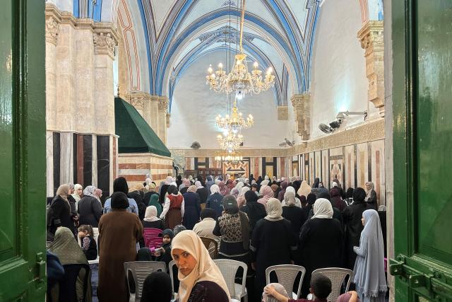 Palestinian women gather to celebrate the Islamic Hijri New Year at the Ibrahimi Mosque, known to Jews as the Cave of the Patriarchs, located inside the Israeli-controlled H2 sector of the occupied West Bank city of Hebron, on June 16, 2026. Israel's finance minister said on June 16, he had stripped Palestinians of authority over the site of the Cave of Patriarchs, known to Muslims as the Ibrahimi Mosque, in the occupied West Bank. The move to transfer management of the site to an Israeli committee controlled by the far-right minister, drew swift condemnation from the Palestinian Authority. (Photo by Hazem BADER / AFP)