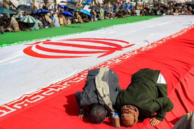 Men prostrate in prayer atop a giant unfurled Iranian flag, as supporters of the Iranian-backed Huthi movement gather at a mass rally, denouncing what they perceive to be derogatory comments by the US president regarding the holy city, in Yemen's Huthi-held capital Sanaa on June 16, 2026. US President Donald Trump had on June 13 had 
criticised the presidential library of his predecessor, Democrat Barack Obama, saying "ten years from now [it] will be a 'Mecca' for those who hate America!", drawing backlash from conservative Muslims.

 
He said Monday that loaded oil tankers were moving out of the strait, apparently on a route near to Oman, in a post on his Truth Social platform. (Photo by Mohammed HUWAIS / AFP)