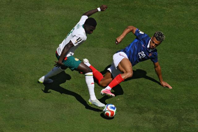 Senegal's midfielder #08 Lamine Camara (L) and France's forward #20 Desire Doue fight for the ball during of the 2026 World Cup Group I football match between France and Senegal at the New York/New Jersey Stadium in East Rutherford on June 16, 2026. (Photo by Angela WEISS / AFP)